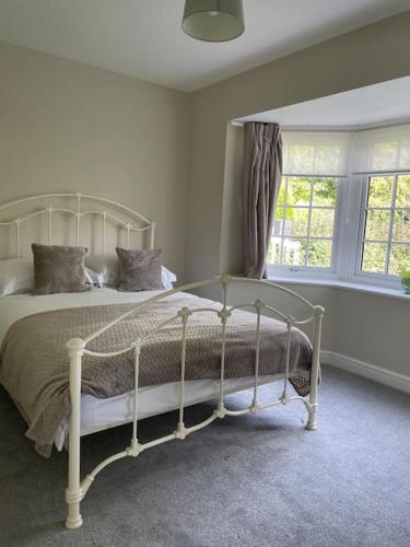 a bedroom with a white bed in front of a window at Spacious, Modern Bungalow in Newton Regis