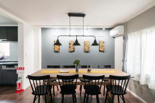 a dining room with a table and chairs at FC Farnest Niseko in Kutchan