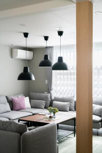 a living room with a couch and a table at FC Farnest Niseko in Kutchan