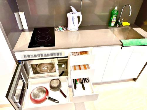 a small kitchen with a sink and a stove at The Luxe Colony Klcc By NTR Resources in Kuala Lumpur