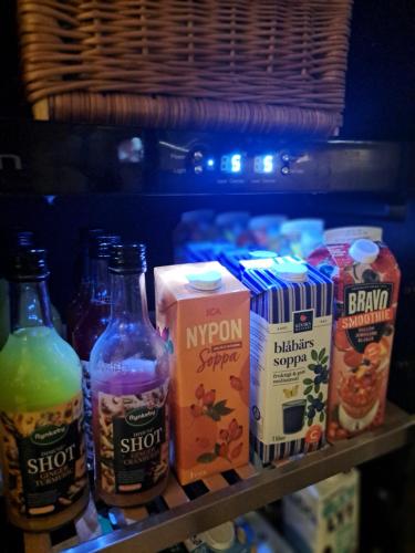 a shelf in a refrigerator filled with different types of drinks at Hotell Rådhuset in Lidköping