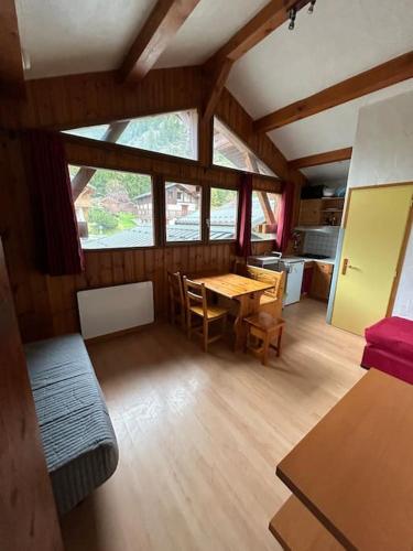 - un salon avec une table et des chaises dans une maison dans l'établissement Studio 4p Louedza, à Pralognan-la-Vanoise