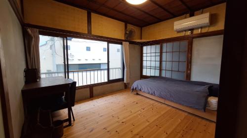 Ένα ή περισσότερα κρεβάτια σε δωμάτιο στο Misaki Guest House ALBE