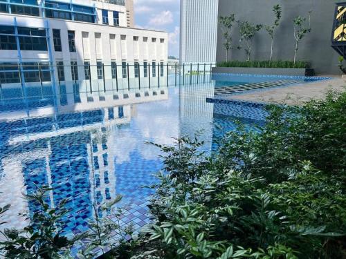 a swimming pool with blue water in a building at Alinea 1912 in Shah Alam