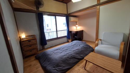 Ένα ή περισσότερα κρεβάτια σε δωμάτιο στο Misaki Guest House ALBE