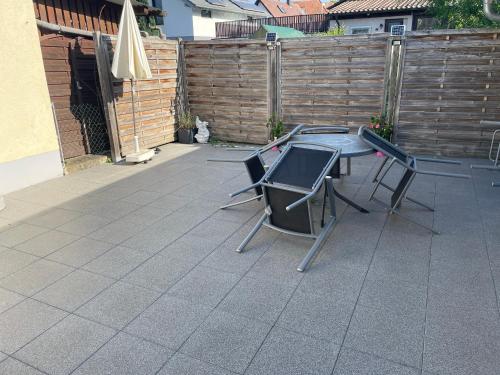 a patio with a table and chairs and a fence at Gästehaus Jeurissen ca 5 Autominuten von Europa-Park Rust oder Rulantica in Kappel-Grafenhausen