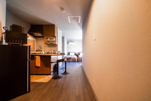 a kitchen with a hallway leading to a living room at Few Days Condominium 602 in Jozankei