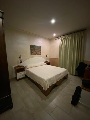 a bedroom with a white bed and a window at Hotel Federico II in Naples