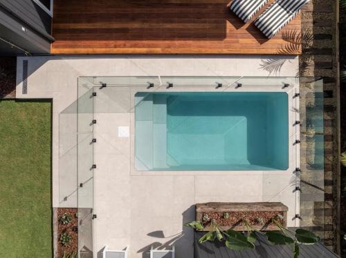a swimming pool on the side of a house at The Cabaway - Cabarita Beach in Cabarita Beach