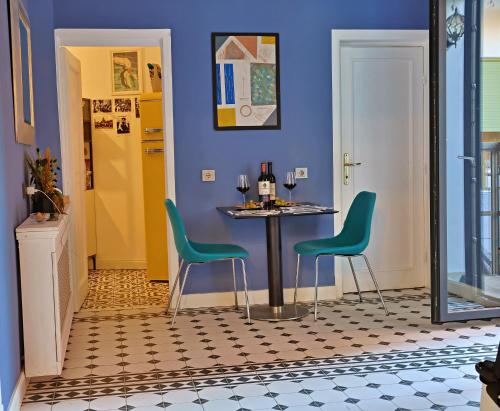 a dining room with a table and two chairs at Art Boutique Residence - City Center - Calea Victoriei in Bucharest