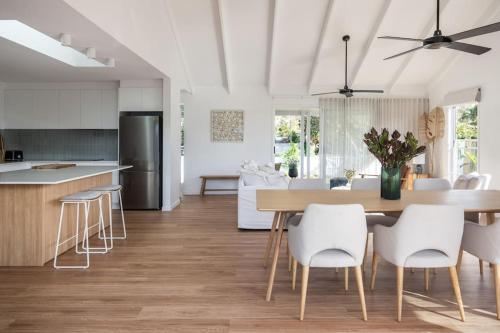 a kitchen and living room with a table and chairs at The Cabaway - Cabarita Beach in Cabarita Beach
