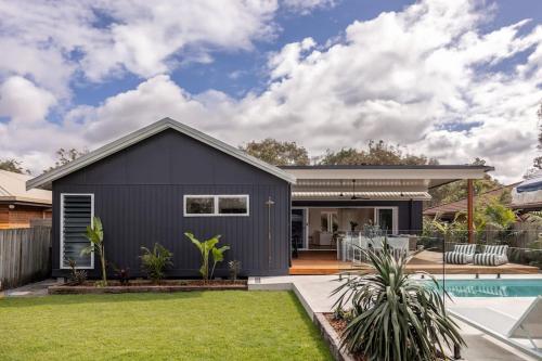 a gray house with a pool and yard at The Cabaway - Cabarita Beach in Cabarita Beach