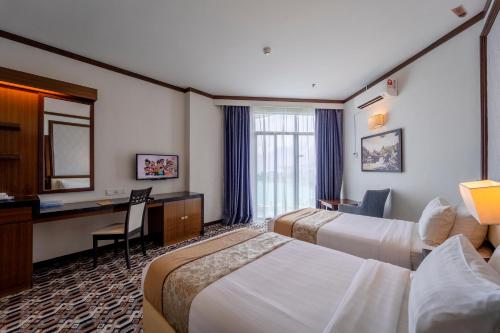 Postel nebo postele na pokoji v ubytování Adya Hotel Kuah Langkawi