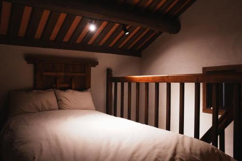 a bedroom with a bed with a wooden headboard at 牧嶼 Nomads' Isle in Jinhu