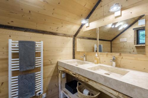 a bathroom with a large sink in a log cabin at Chalet Chataigne - Magnifique vue montagne in Cornimont