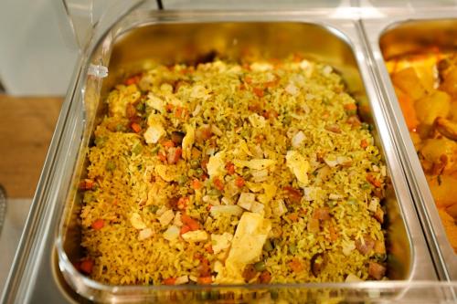 a plastic container filled with rice and vegetables at 사이공 트래블 라운지 Saigon Travel Lounge in Ho Chi Minh City