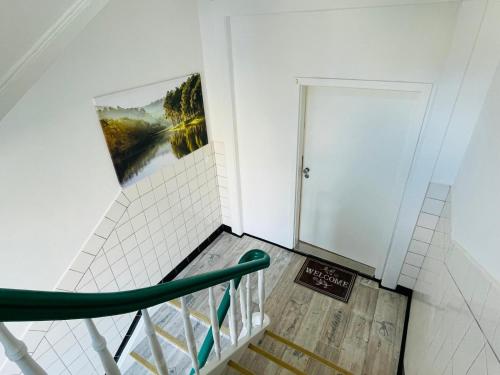 a staircase in a room with a painting on the wall at Top Apartments in Kamen - Cozystays in Kamen