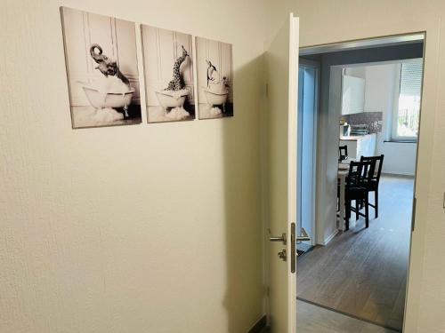 a hallway with three pictures of toilets on a wall at Top Apartments in Kamen - Cozystays in Kamen