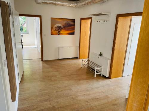 an empty room with wooden floors and a painting on the wall at Top Apartments in Kamen - Cozystays in Kamen