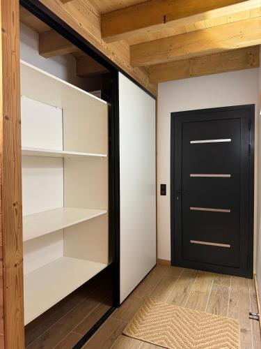a walk in closet with a black door at Chalet de montagne Sant Feliu Feliu à Dorres in Dorres