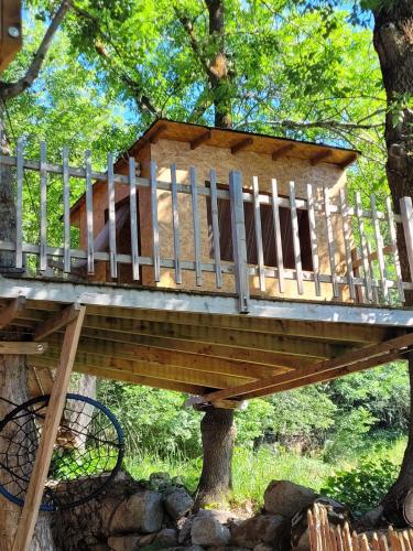a tree house with a deck on a tree at Chalet de montagne Sant Feliu Feliu à Dorres in Dorres