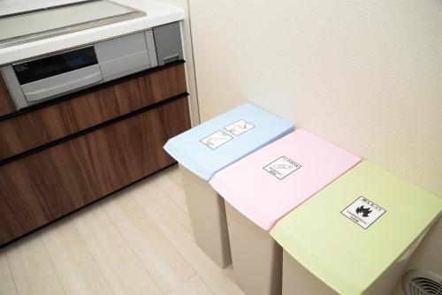 two boxes sitting on top of a table in a kitchen at NYHotel 1 新宿2階建て4室1バスルーム1シャワー2トイレ in Tokyo