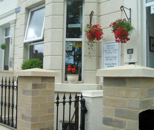 a building with flower pots on the side of it at All Seasons Guest House in Great Yarmouth