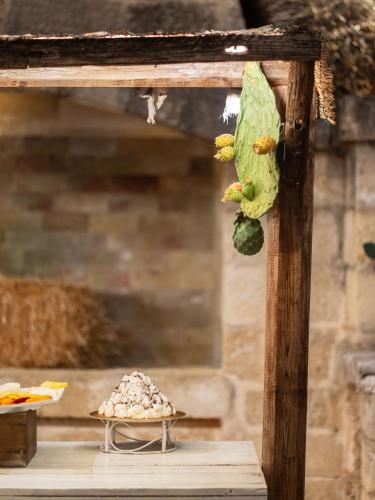 a large green caterpillar hanging from a wooden pole at Antica Masseria Martuccio in Mesagne