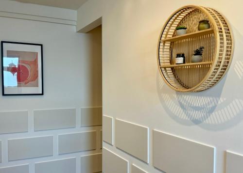 a room with a wicker shelf on the wall at MEINpartments - Modern Business Apartment in Wolfsburg