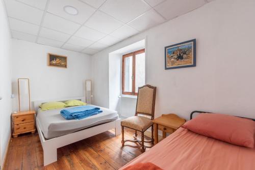 a bedroom with two beds and a desk and a chair at gite D ETAPE DU PELERIN de la butte aux oiseaux in Saint-Alban-sur-Limagnole
