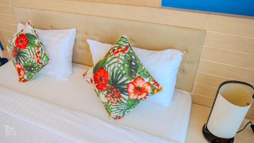 two pillows sitting on top of a bed at Samed Port View in Ko Samed
