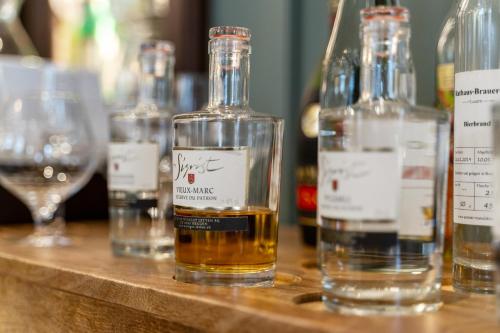 a bottle of whiskey sitting on a table with wine glasses at Waldstätterhof Swiss Quality Hotel in Luzern