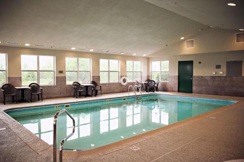 a large swimming pool with chairs and a table at Country Inn & Suites by Radisson, Frackville (Pottsville), PA in Mount Pleasant