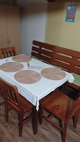 a table with four chairs and a white table cloth at Trempská Chalupa Aronie in Olešnice v Orlických horách