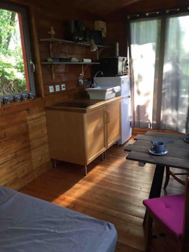 - une cuisine avec un comptoir et une table dans une cabine dans l'établissement Jolie Roulotte tout confort, à Saint-Amand-les-Eaux