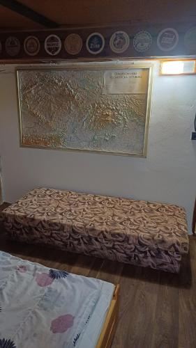 a room with two beds and a painting on the wall at Trempská Chalupa Aronie in Olešnice v Orlických horách