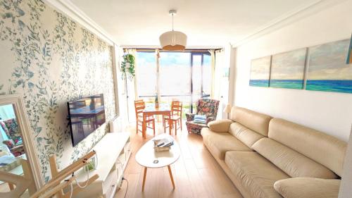 a living room with a couch and a table at Somo Playa Vistas in Somo