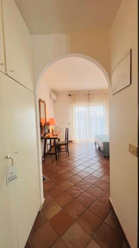 a hallway with a room with a table and a bed at Bay Palace Mazzarò in Taormina