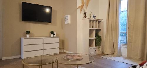 - un salon avec une télévision et une commode dans l'établissement Studio d athis, à Athis-Mons