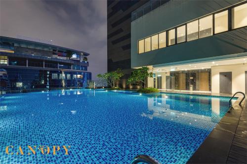 a large swimming pool in front of a building at The Manor Signature Residence, Kuala Lumpur in Kuala Lumpur