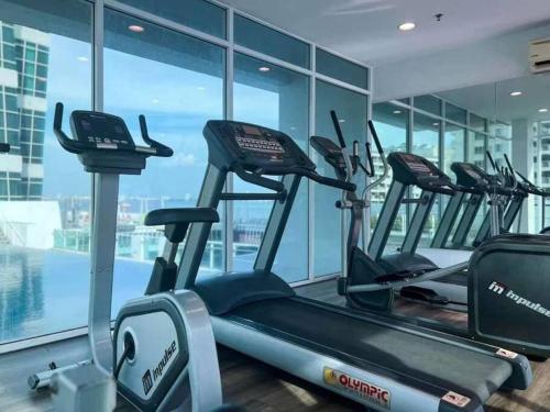 a gym with a row of cardio machines at Seaview Seafront Duplex in Town with WiFi & Full Kitchen 83A in Georgetown