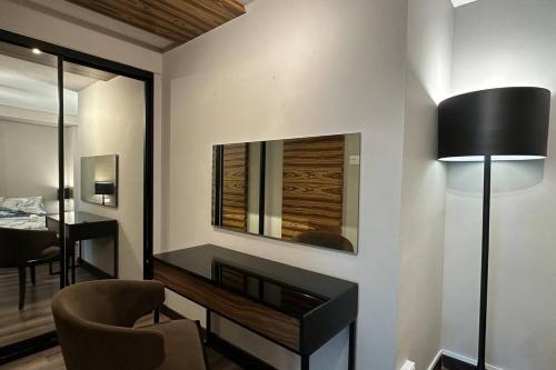 a living room with a desk and a mirror at Seaview Seafront Duplex in Town with WiFi & Full Kitchen 83A in Georgetown