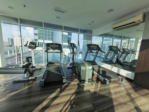 a gym with several treadmills in a building at Seaview Seafront Duplex in Town with WiFi & Full Kitchen 83A in Georgetown