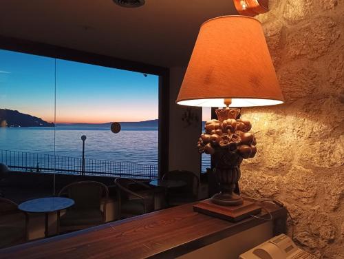 a lamp sitting on a table in front of a window at Bay Palace Mazzarò in Taormina