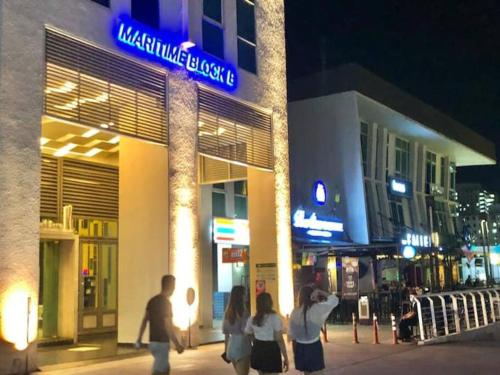 a group of people walking in front of a building at Seaview Seafront Duplex in Town with WiFi & Full Kitchen 83A in Georgetown