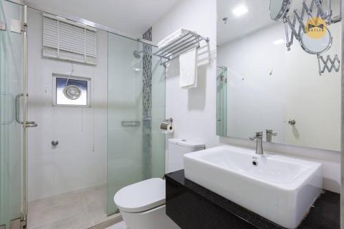 a bathroom with a sink and a toilet and a shower at Seaview Seafront Duplex in Town with WiFi & Full Kitchen 83A in Georgetown