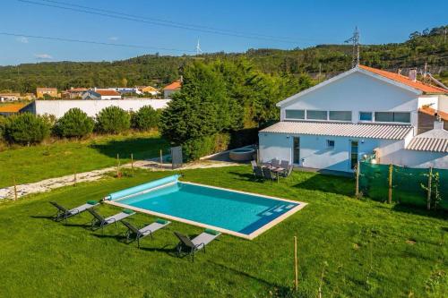 an aerial view of a house with a swimming pool at Casa Sol - Private Pool with a Large Garden in Mouchinha