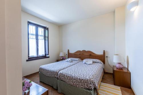 a bedroom with a bed and a window at Cascina Gaggioli in Milan