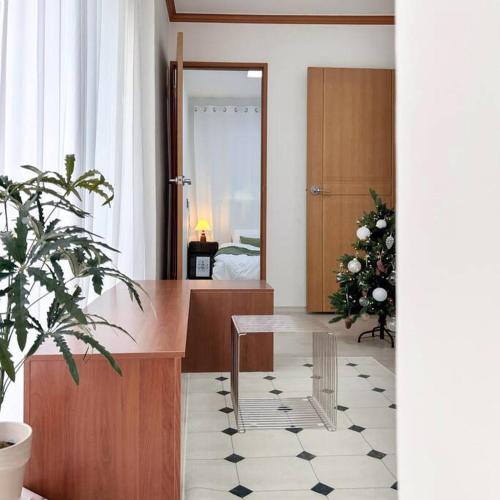 a living room with a christmas tree and a desk at busan&u 2 in Busan