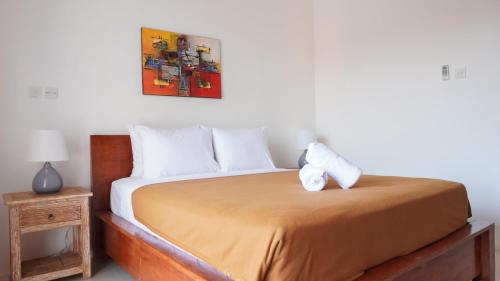 a bedroom with a bed with two towels on it at Summer of Surf Canggu in Canggu
